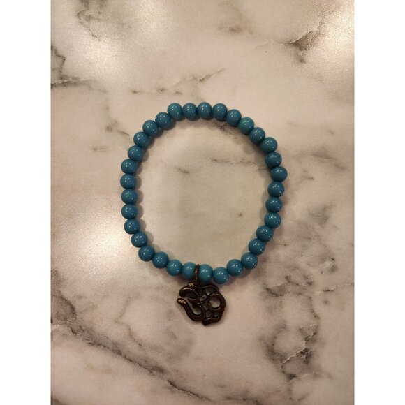 Turquoise Blue Beaded Bracelet With Bronze Om Symbol Charm - Picture 1 of 3